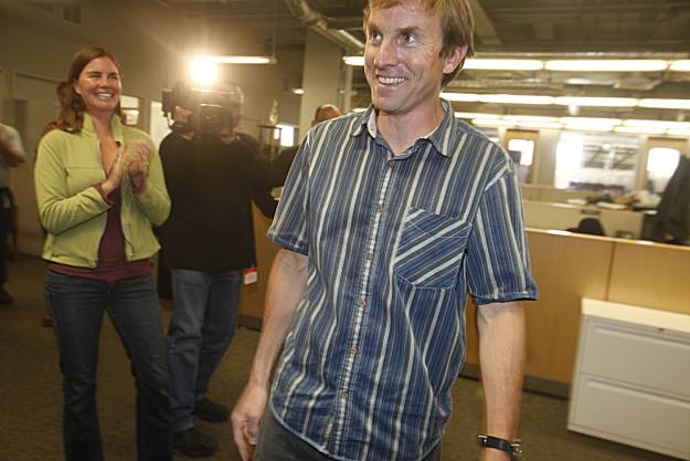 Pulitzer Prize- winning cartoonist Mark Fiore receives applause from his wife, Chelsea Donovan, and colleagues at the SFGate offices.Photo: Mike Kepka / The Chronicle?<br />